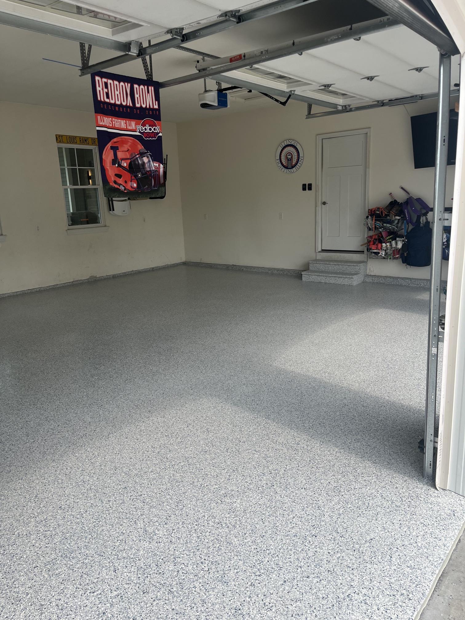 Finished grey flake epoxy garage floor with coated entry stairs