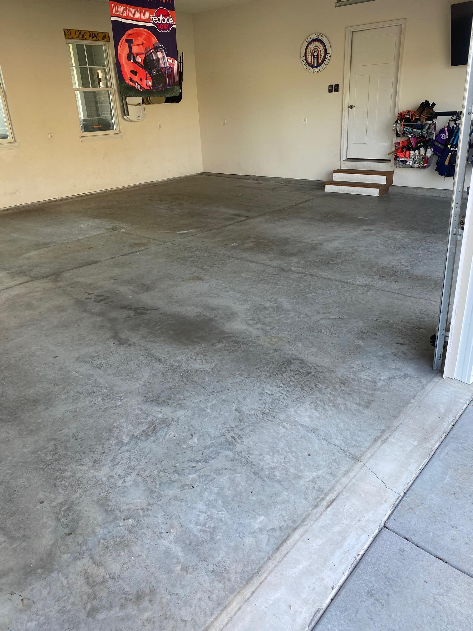Bare stained concrete garage floor before flake coating