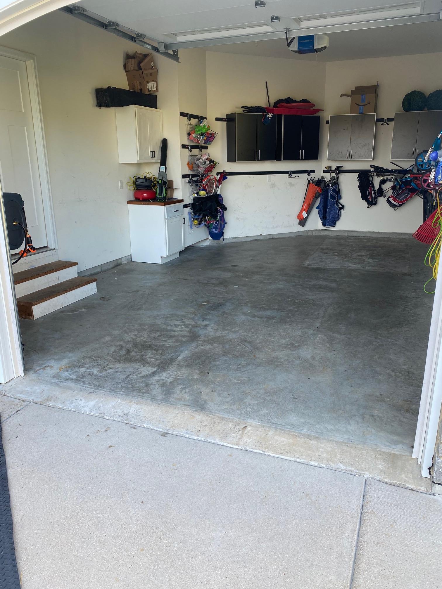 Side view of unfinished garage concrete and wood entry stairs before coating